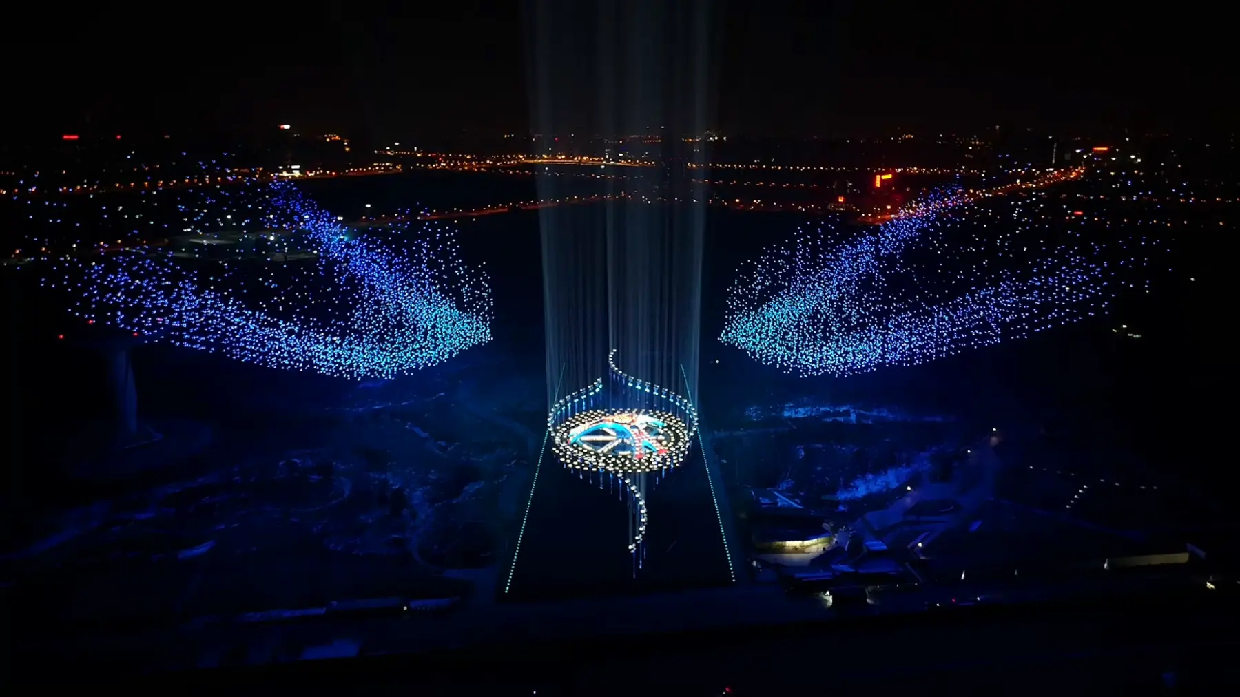 Drone formation shaped like outstretched wings over the horizon
