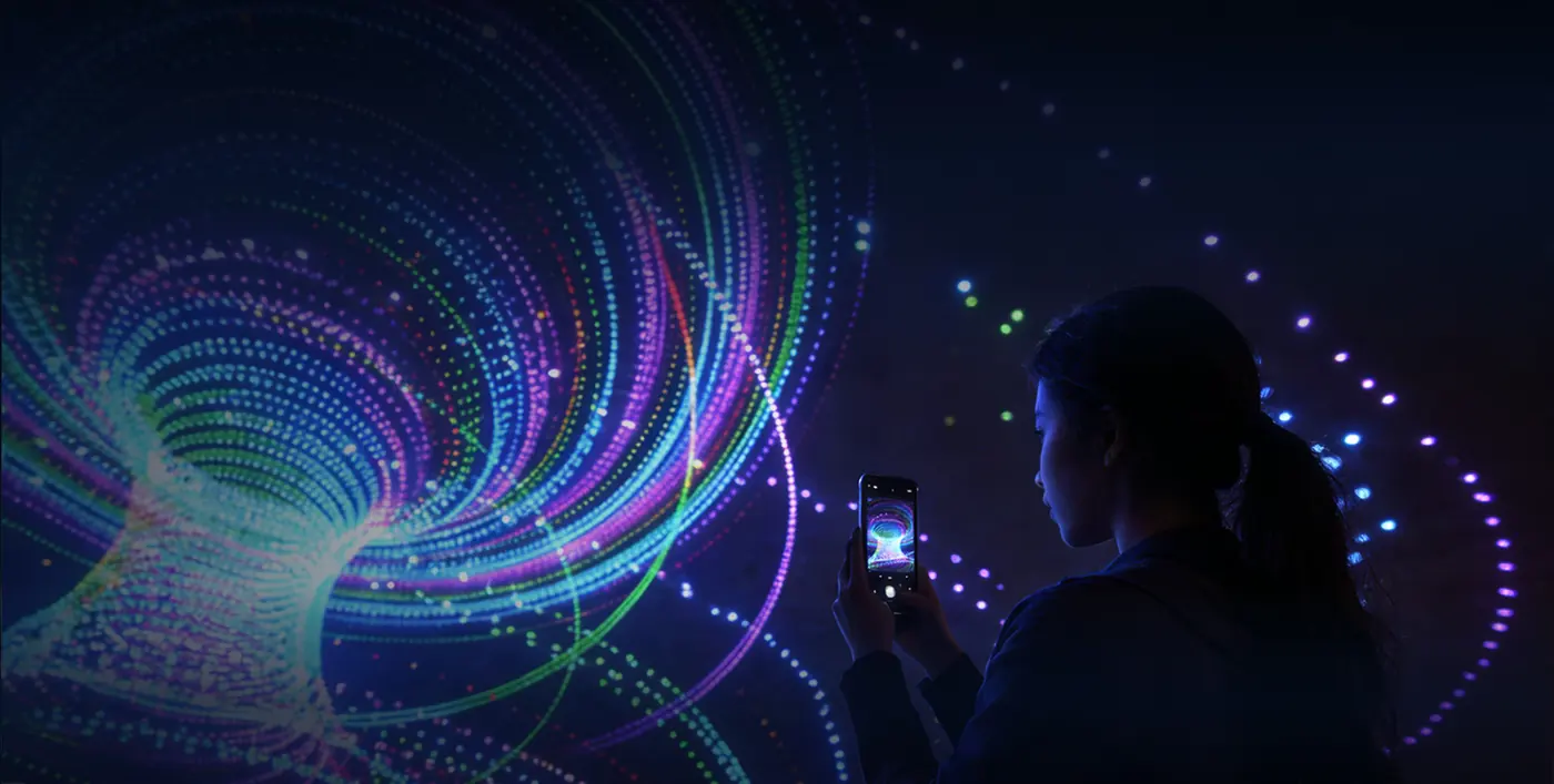 Spiral of light with the silhouette of a spectator watching the show